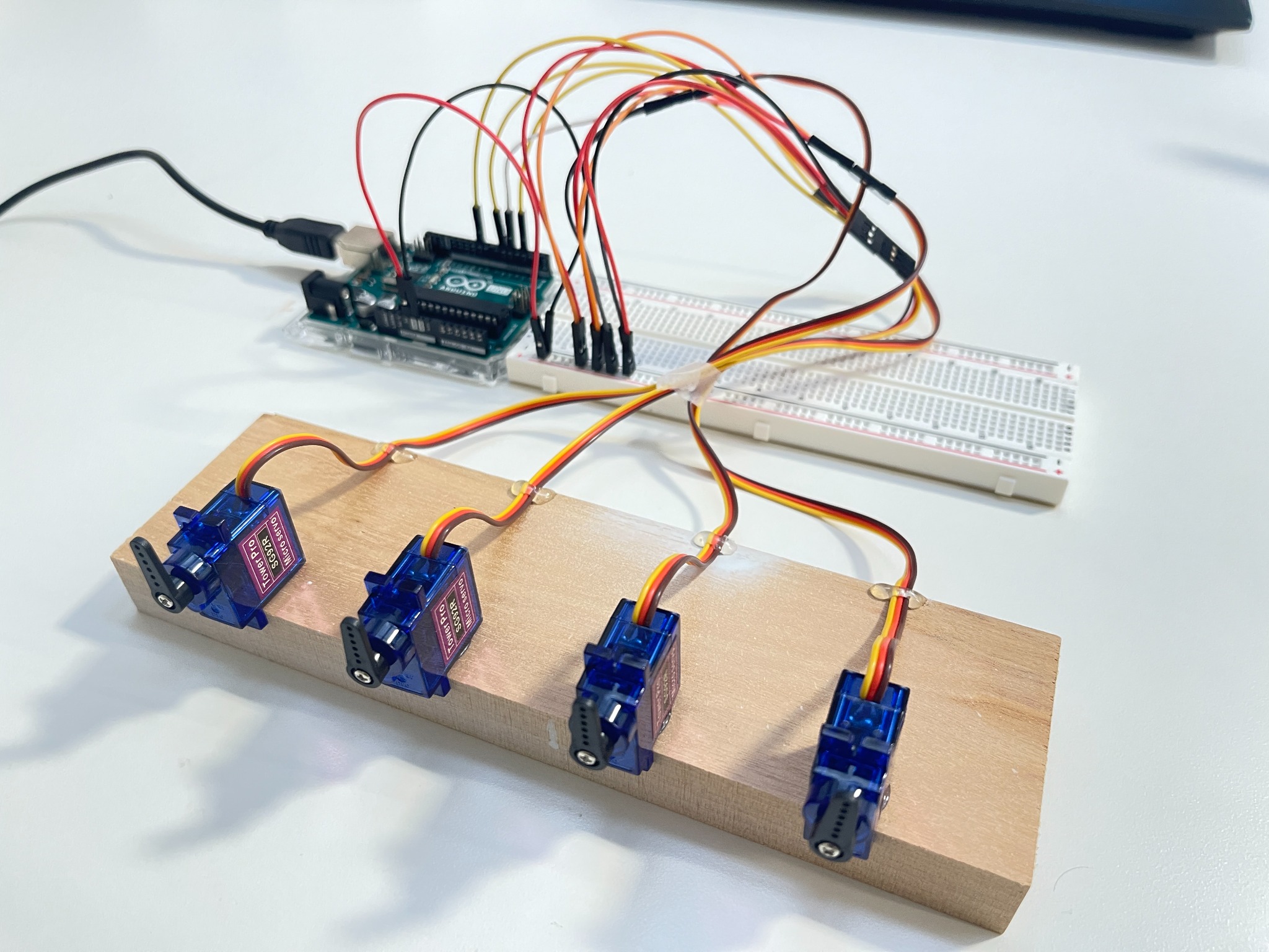 SemaForm Arduino Uno prototype with four servo motors mounted on a wooden strip